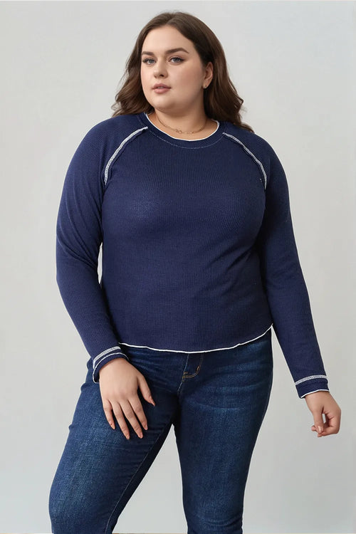 Dark blue long raglan sleeve top with round neck and white contrast trim at seams