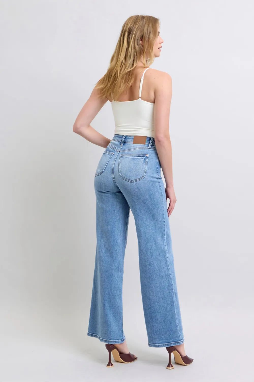 Medium-wash wide-leg jeans, back view with center seam and rear pockets