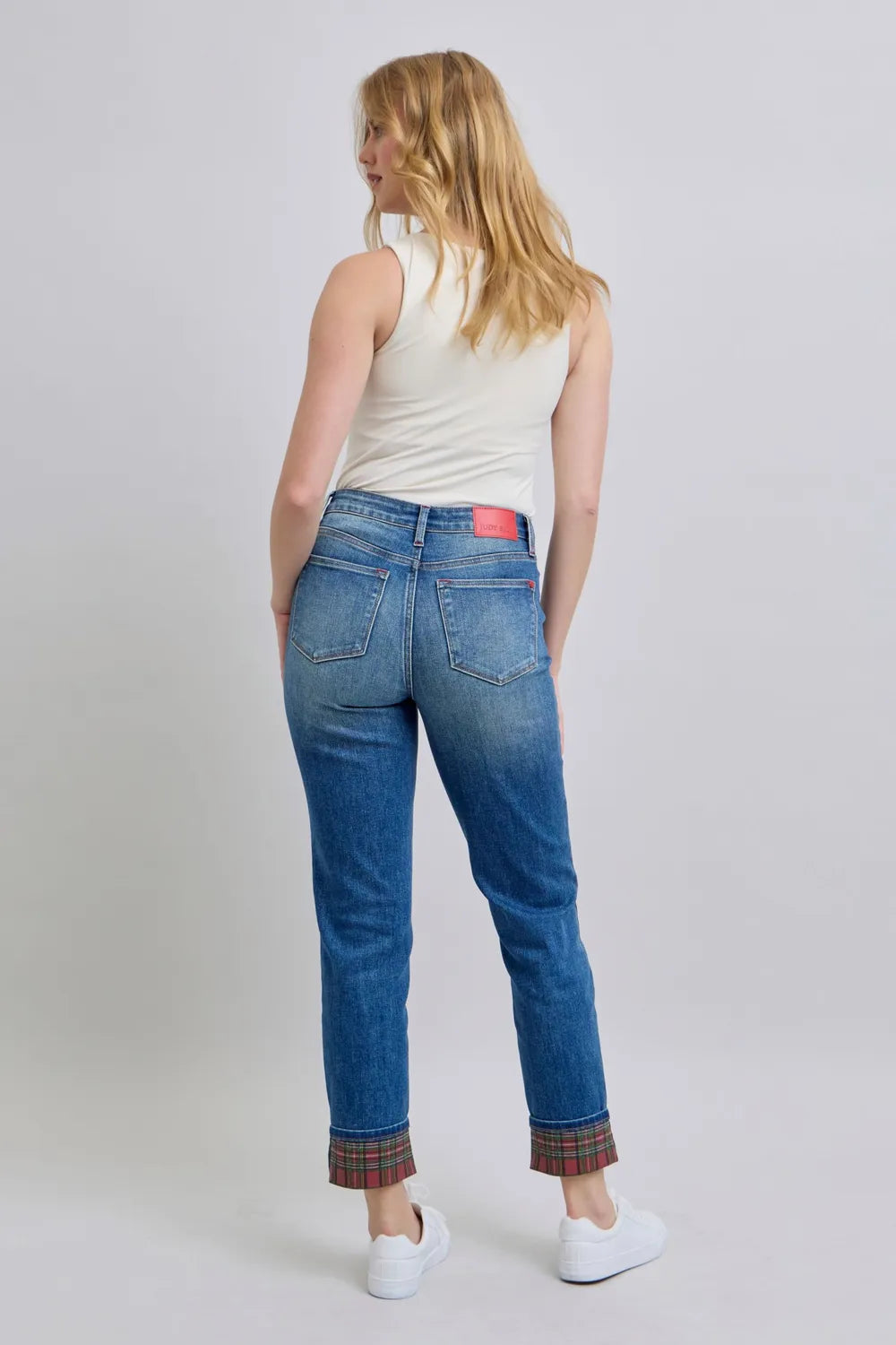 Medium wash jeans, back view with plaid cuffs and back pockets