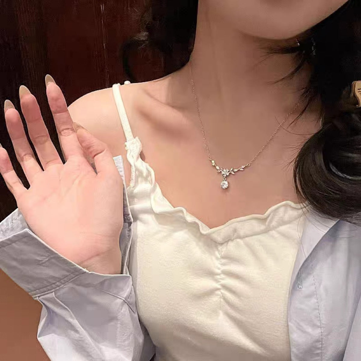 Moissanite leaf flower necklace worn with leaf-detail centerpiece and round drop pendant