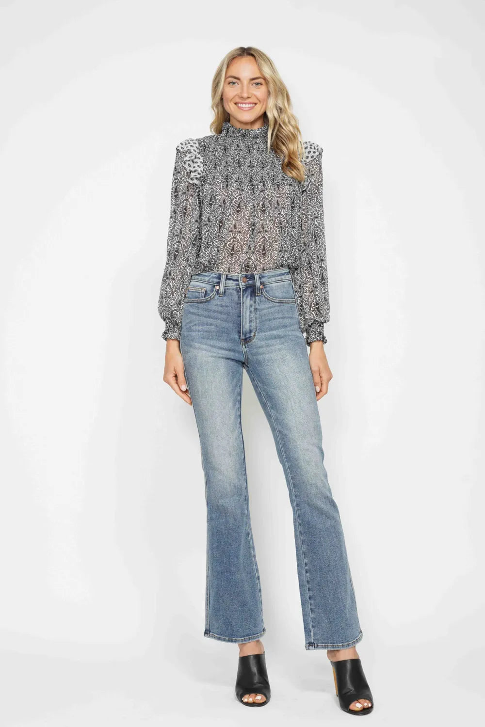 Medium-wash blue bootcut jeans, front view; belt loops and front pocket stitching