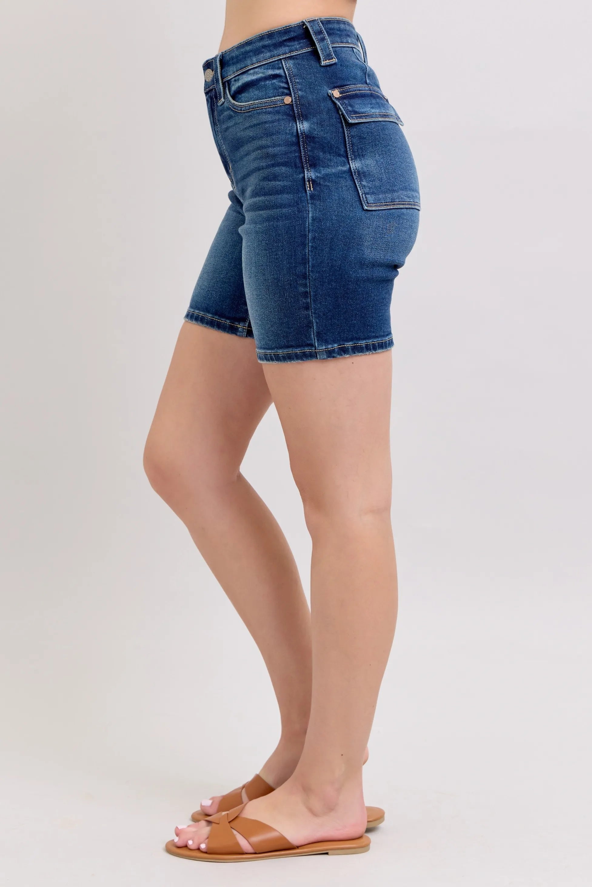 Side view of high-waist denim bermuda shorts with back flap pocket detail