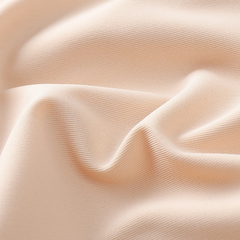 Beige bra fabric close-up with smooth stretch texture