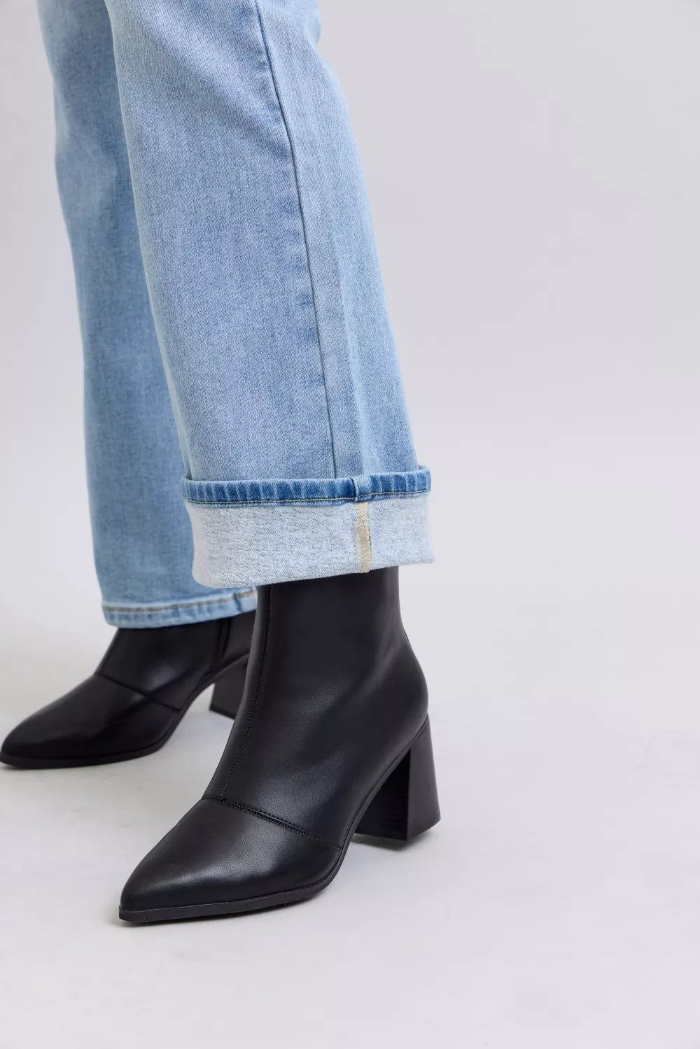 Bootcut jean hem with cuff and black heeled ankle boots