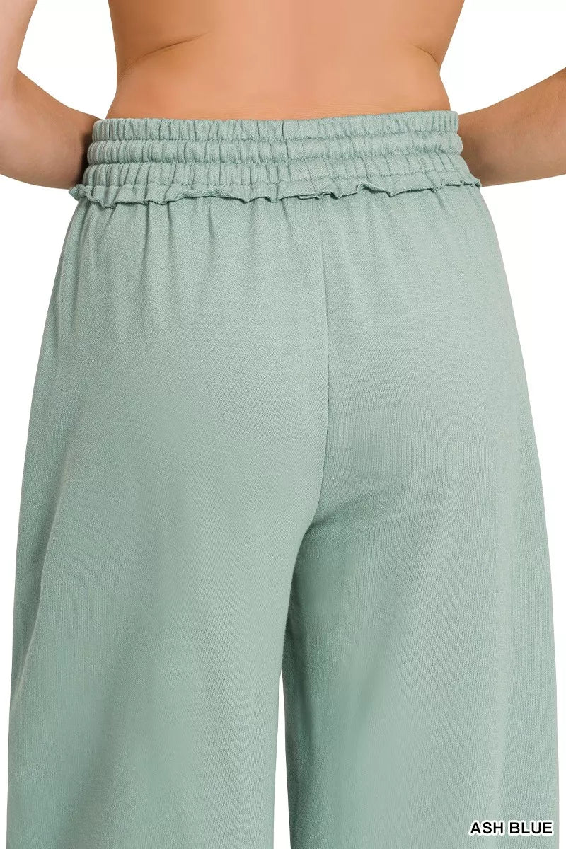 Wide-leg sweatpants in ash blue with elastic waistband and layered drawstring