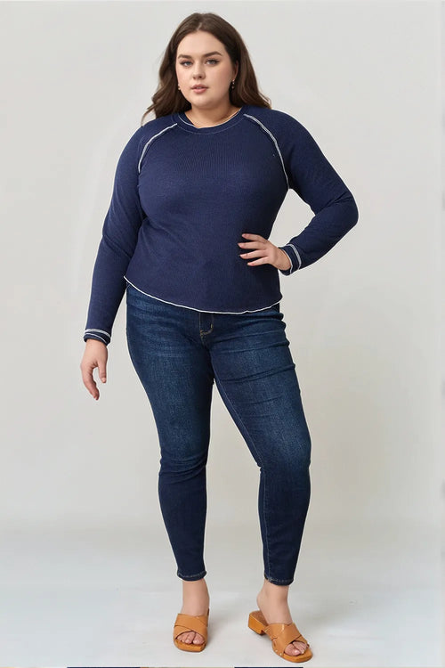 Dark blue raglan long-sleeve top, round neckline, white piping detail along sleeves