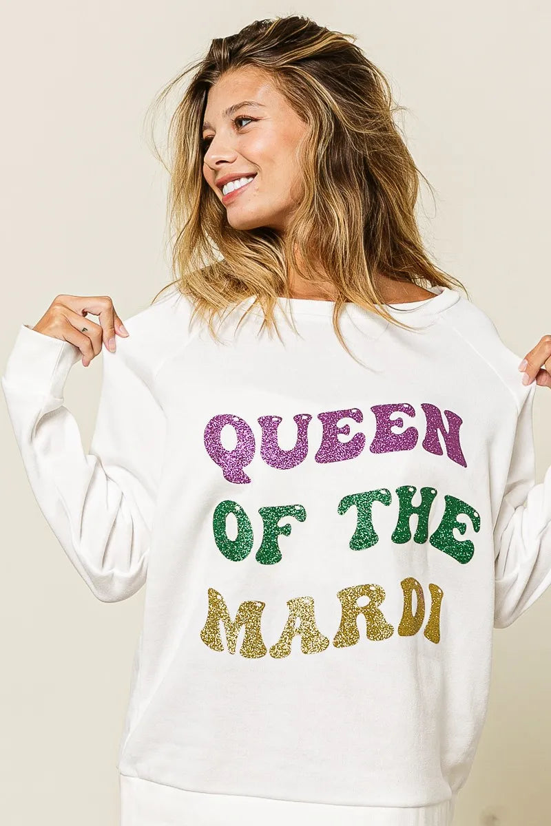 Off-white pullover sweatshirt with glitter “QUEEN OF TH3 MARDI” text on front