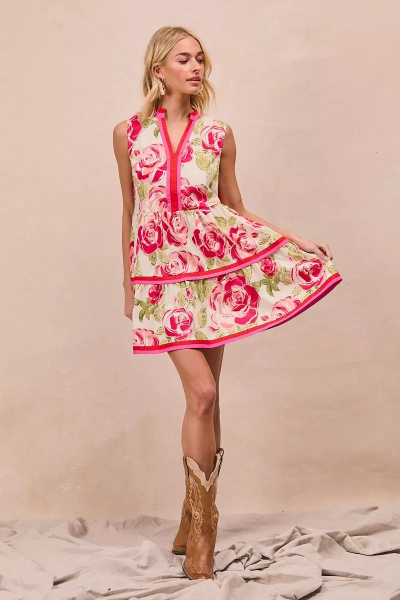 Coral rose print tiered mini dress with contrast pink border and sleeveless silhouette