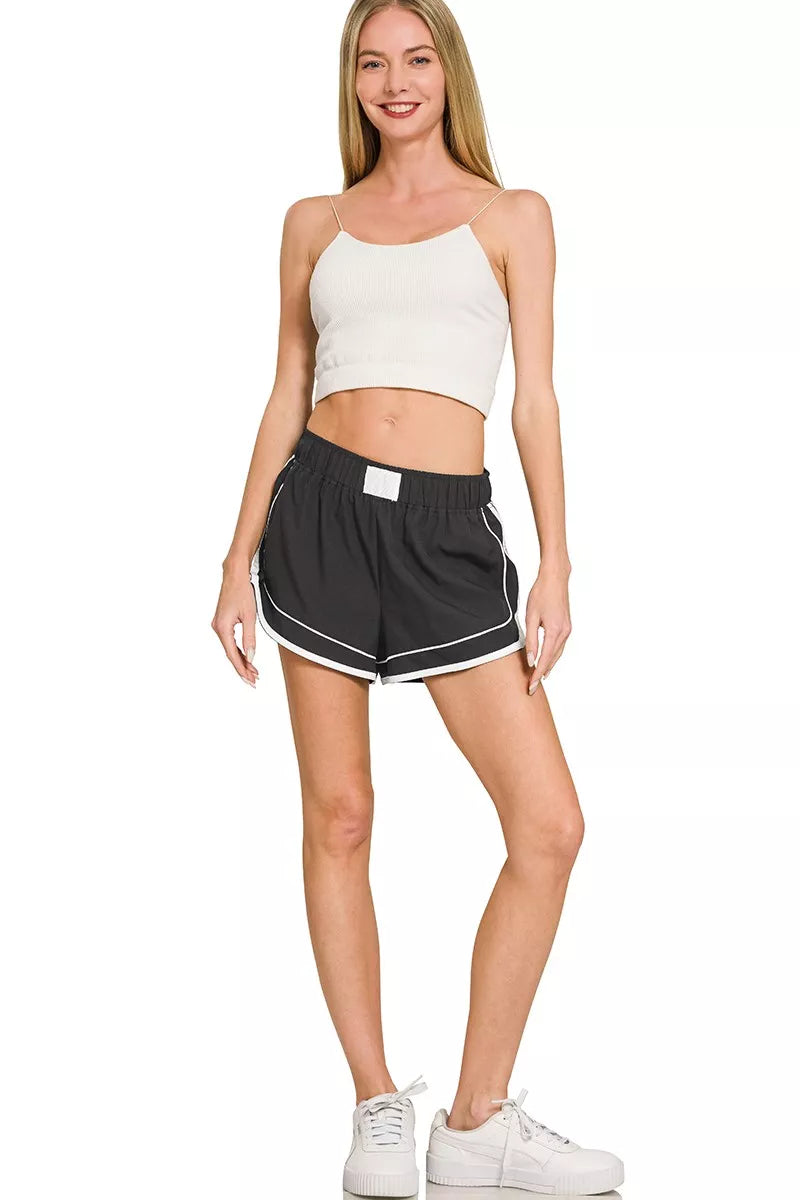 Black soft woven lined dolphin shorts with white-trimmed dolphin hem, front view