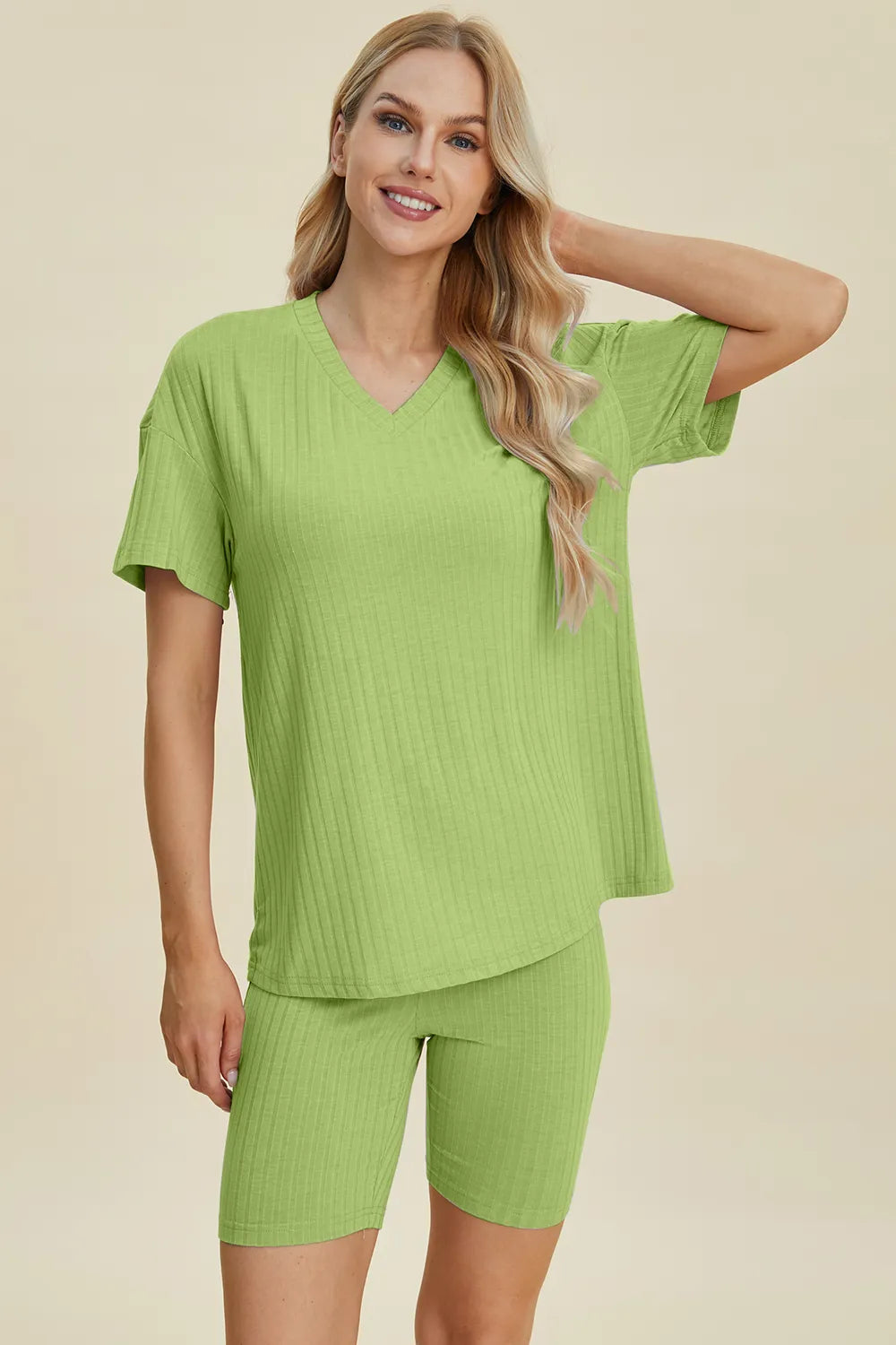 Green ribbed V-neck short sleeve top and matching biker shorts set, side front view