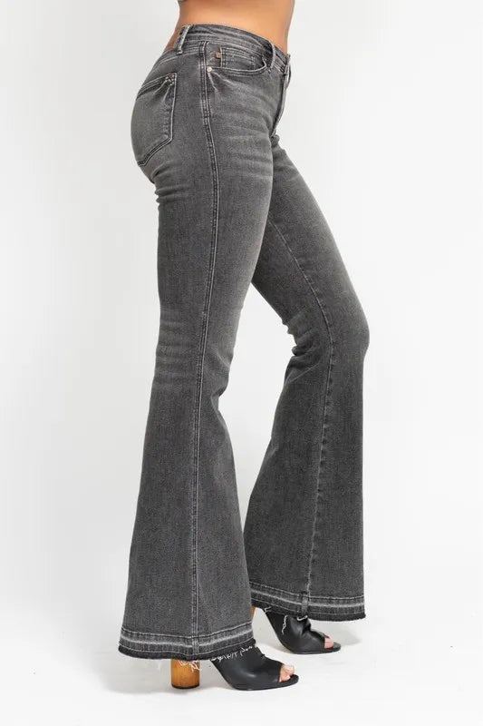 Washed gray mid-rise flare jeans, side view with frayed release hem and curved leg opening