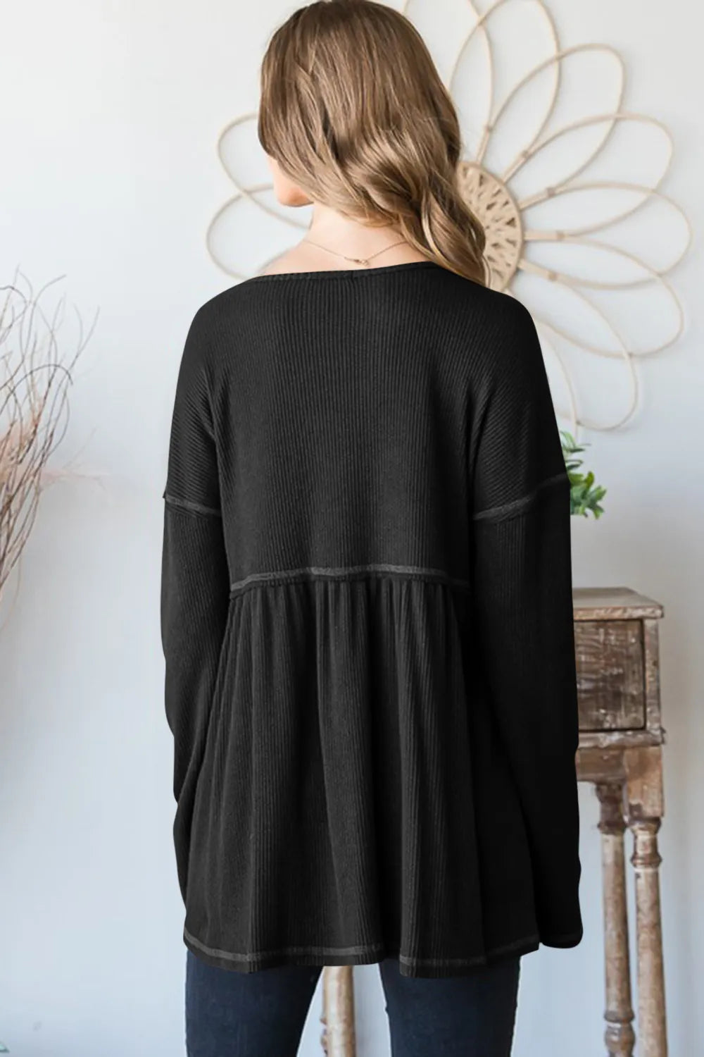 Black ribbed babydoll top, long sleeves; back view with gathered skirt panels