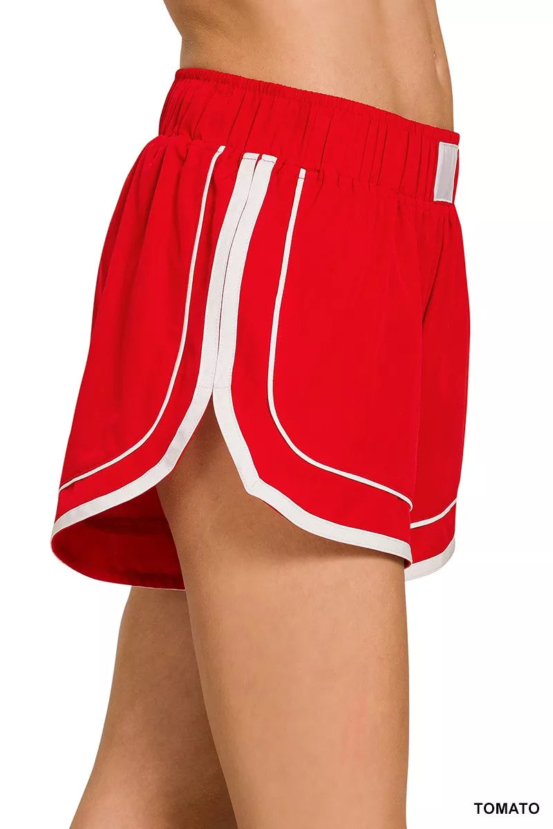 Tomato red shorts with elastic waist and curved white side trim