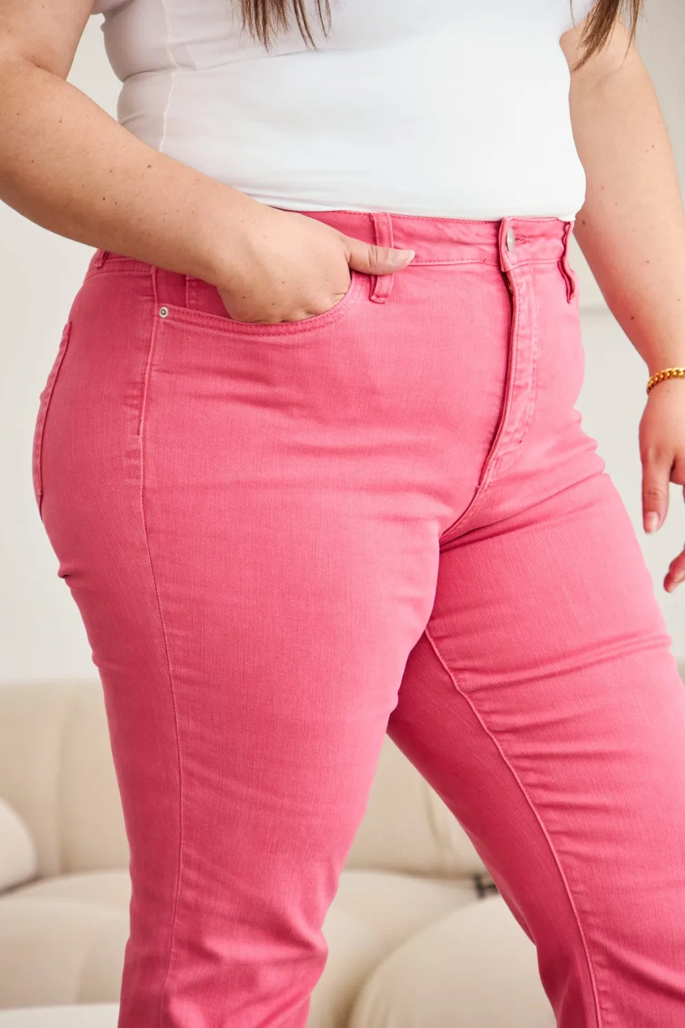 Sunkissed pink high-waist jeans with raw frayed hem and button closure