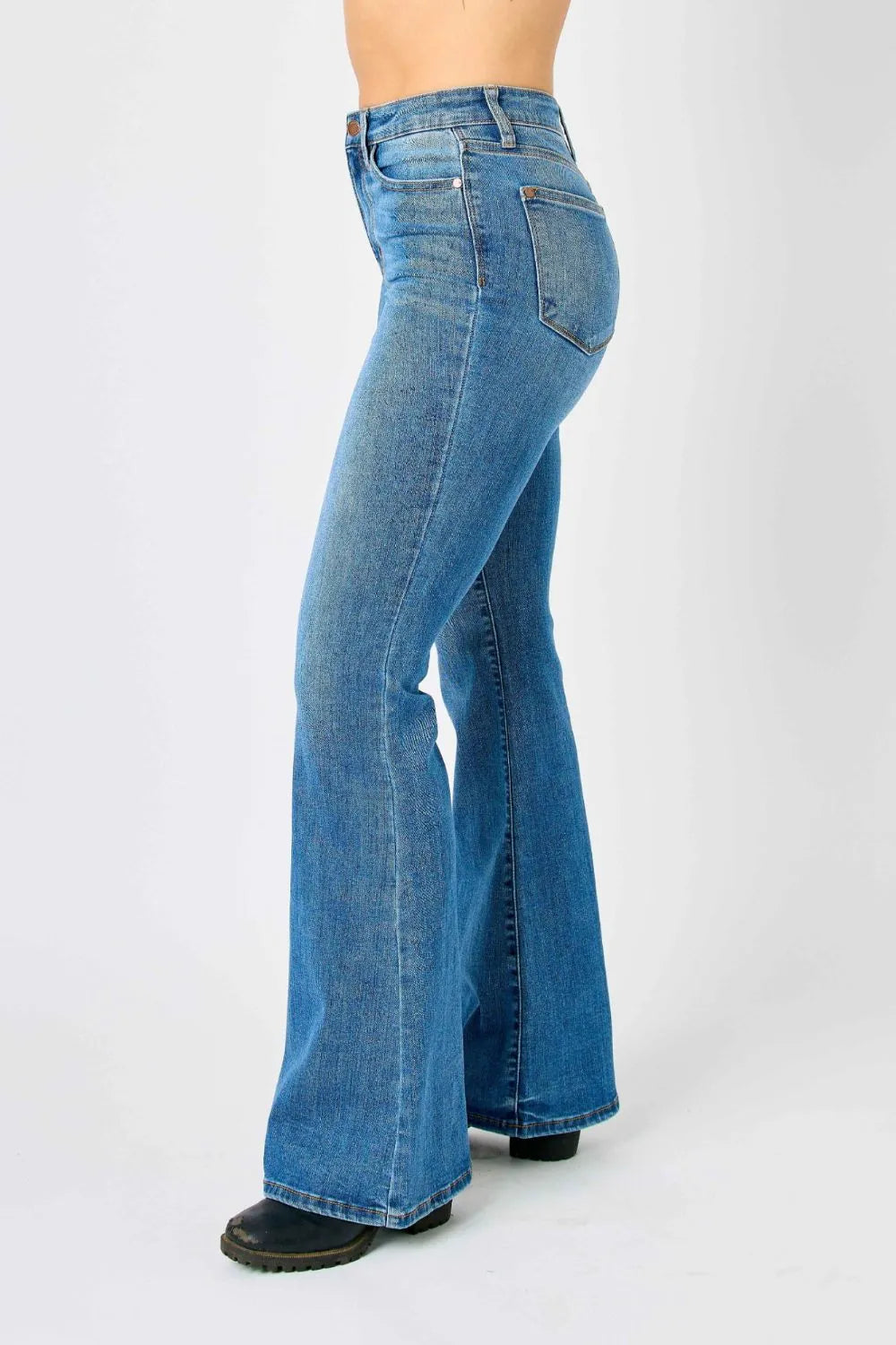 Back view of high-waisted flare jeans in medium-blue denim with back pockets