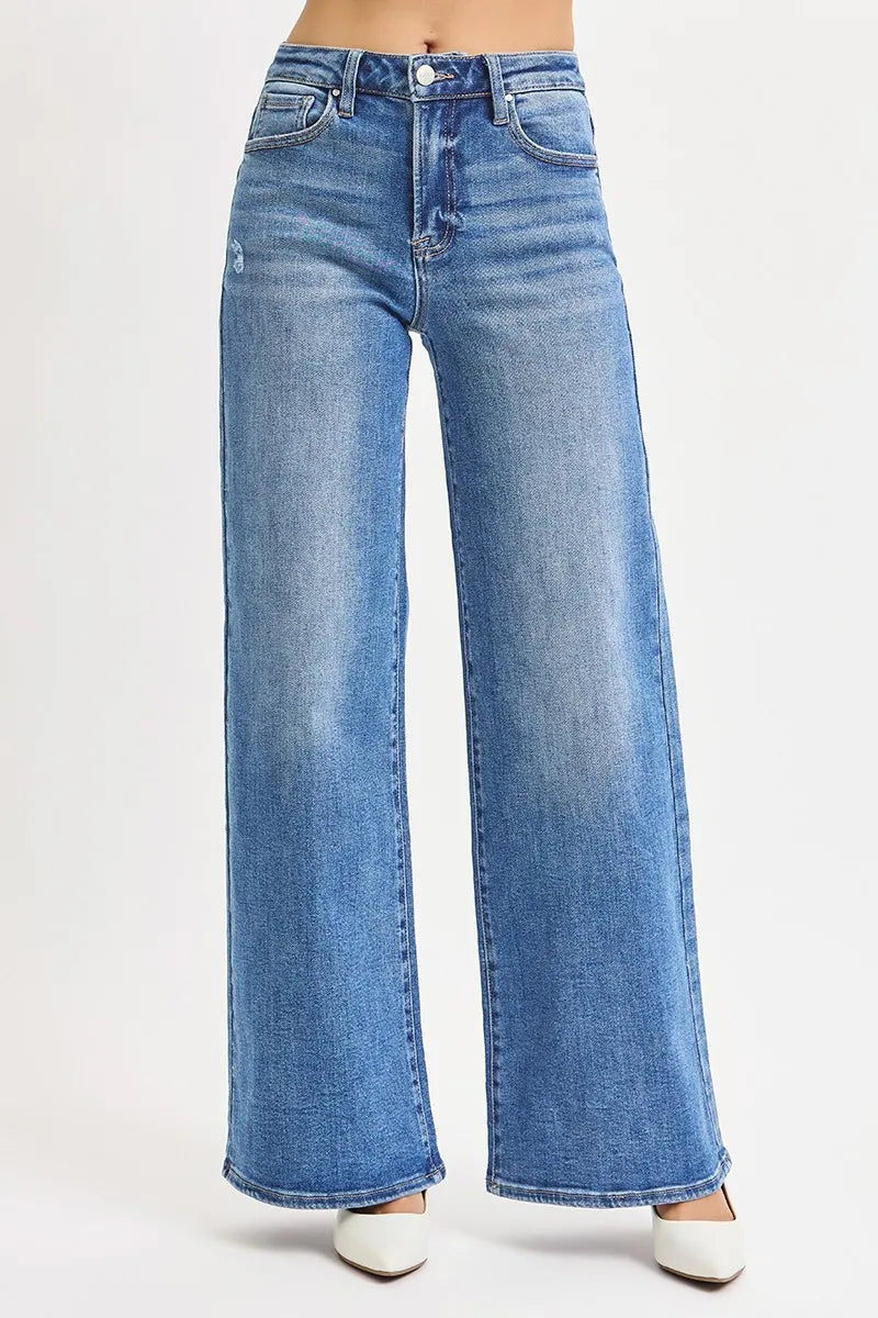 High-rise wide-leg jeans in medium wash blue, subtle fading and long stitched seams.