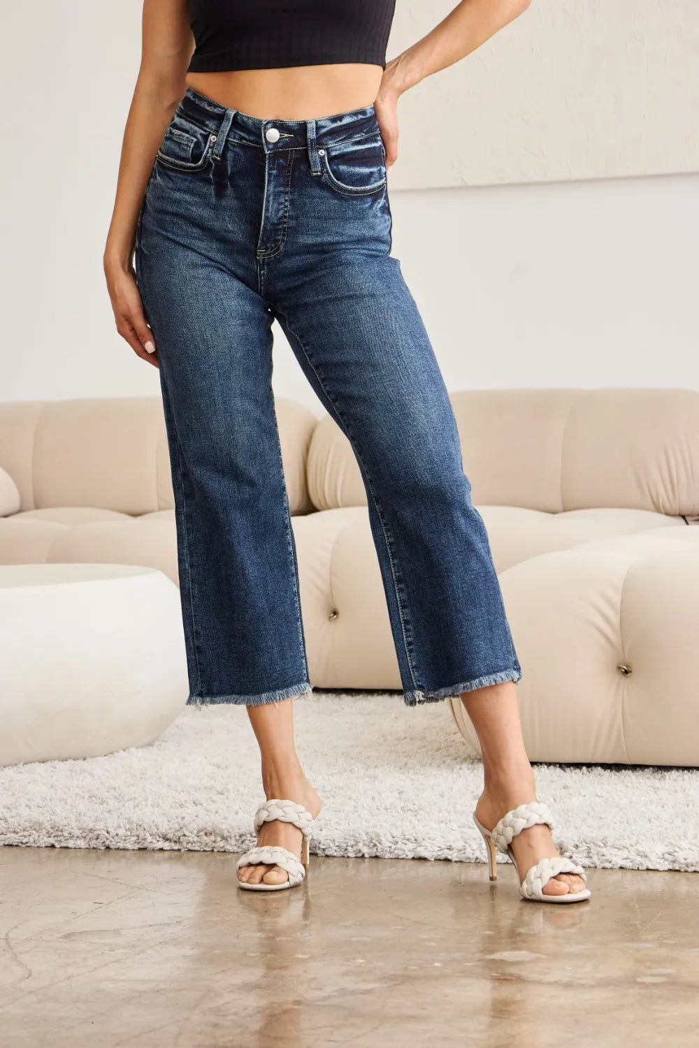 High-rise dark-wash jeans with straight-to-flare leg and raw cuff hem