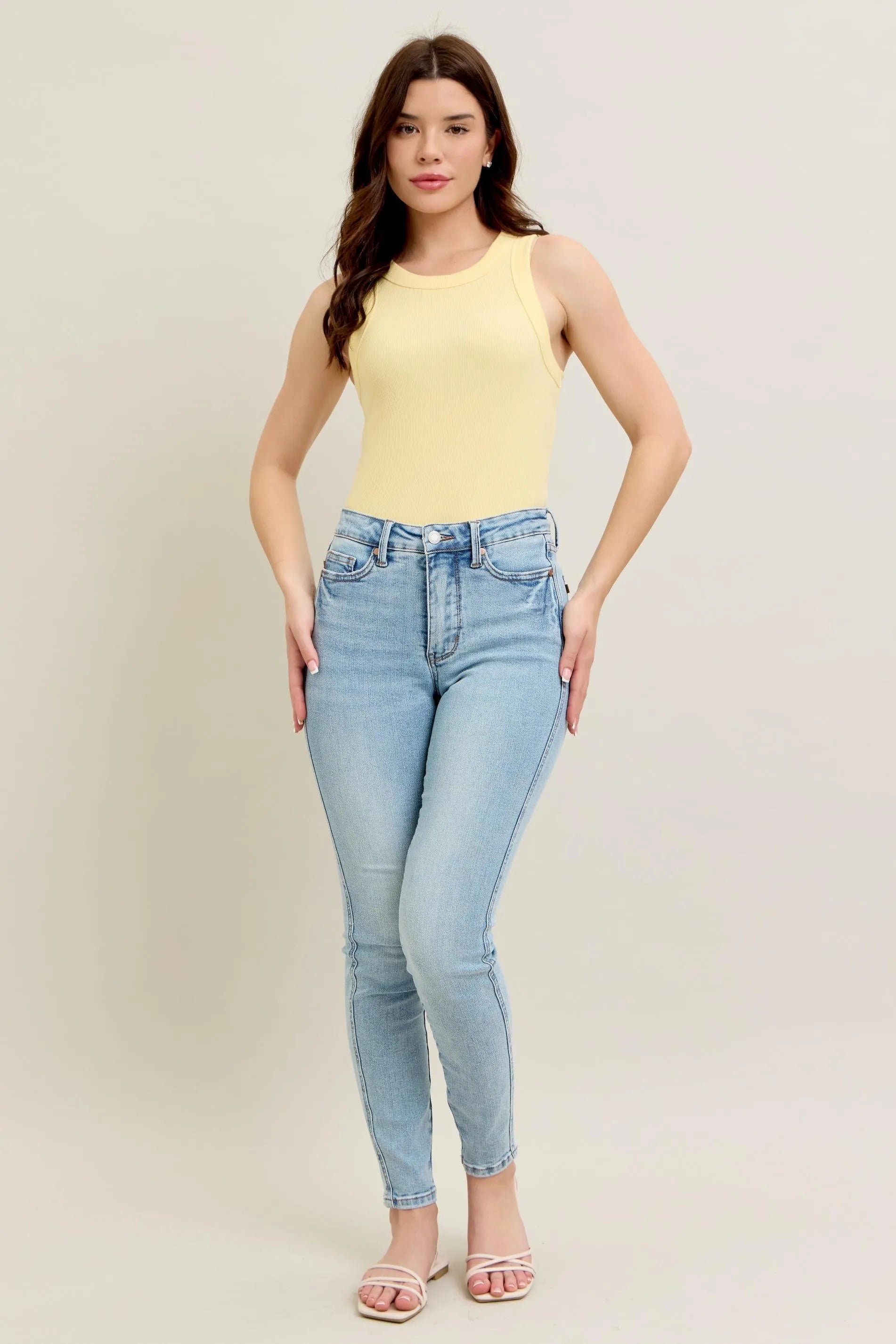 Light wash skinny jeans, high-rise plus size, front view with belt loops and pockets
