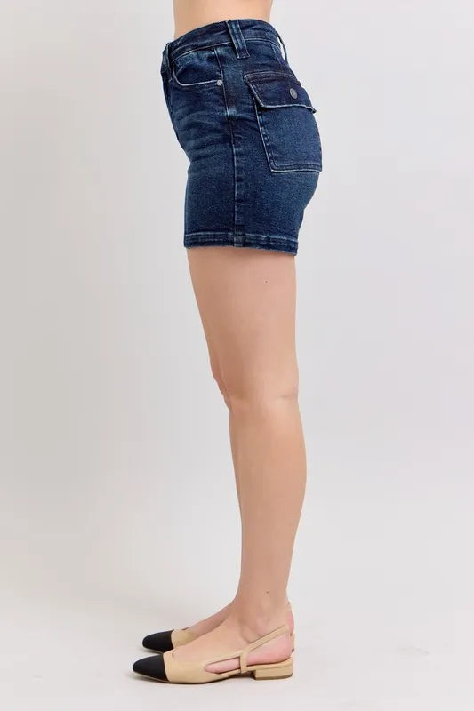 Side profile dark denim shorts with high-rise waistband and back flap pocket