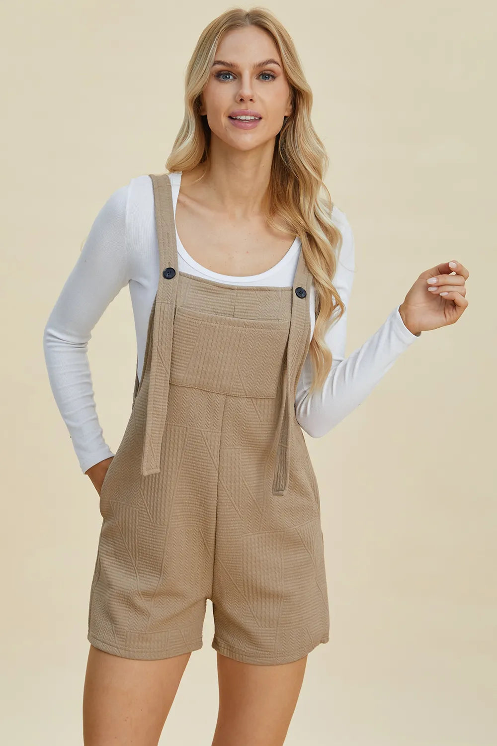 Khaki textured sleeveless romper with square neckline and adjustable front straps