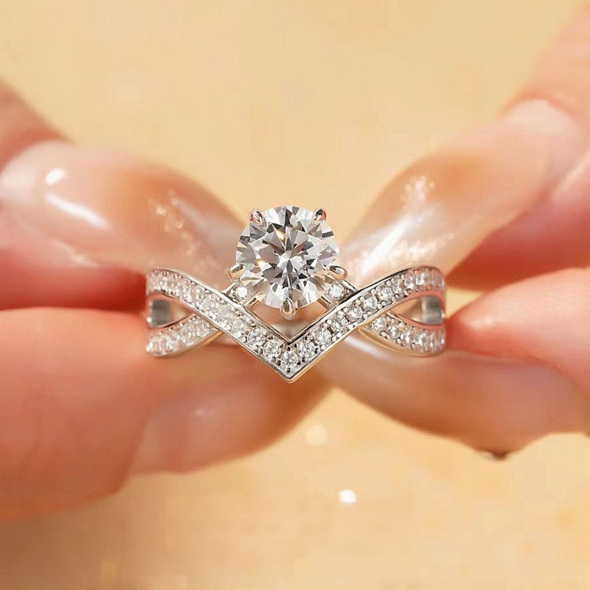 Moissanite engagement ring with round center stone and open V pavé band