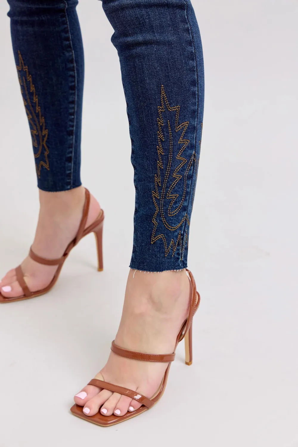 Embroidered dark blue skinny jeans ankle cuff detail with dark stitching pattern