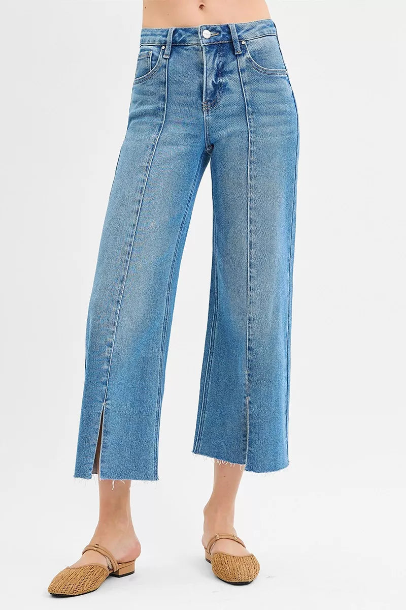Medium-wash mid-rise wide-leg jeans with front slit, tummy control crop