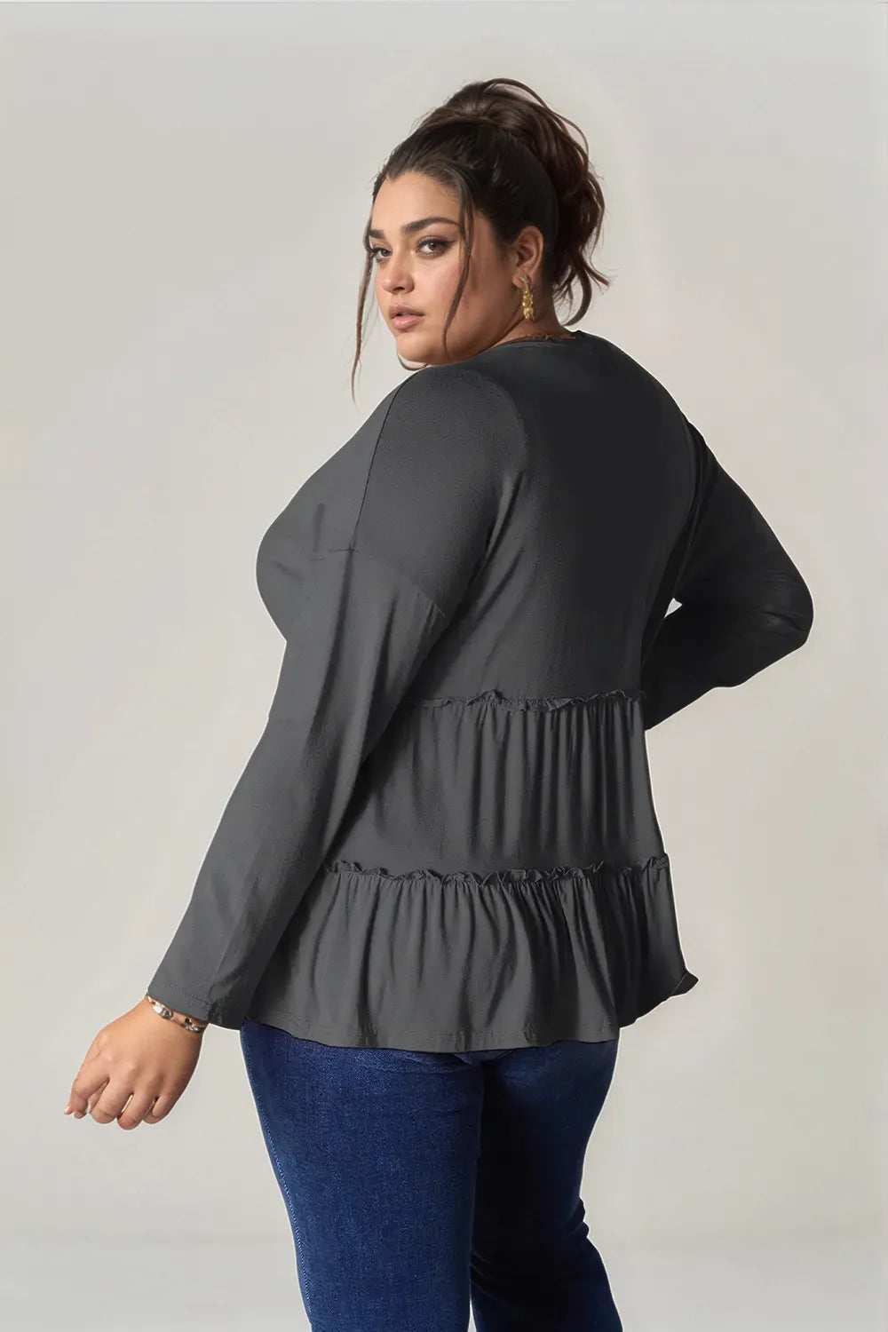 Dark gray long-sleeve blouse with gathered waist and tiered ruffle hem, back view