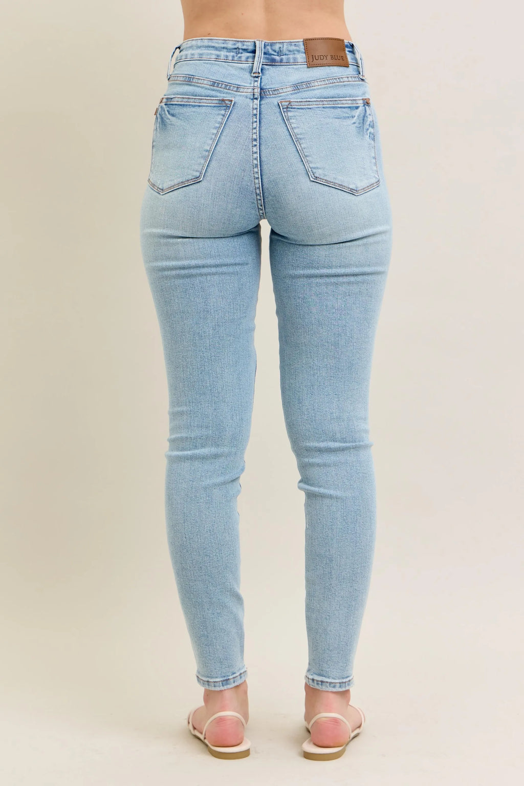 Light wash skinny jeans, rear view, slim tapered fit with belt loops