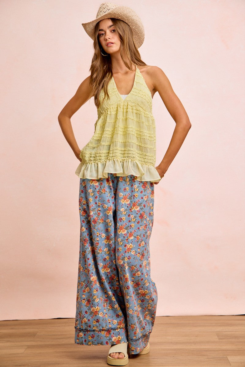 Denim blue floral wide-leg pants with elastic waistband and drawstring ties; ankle length