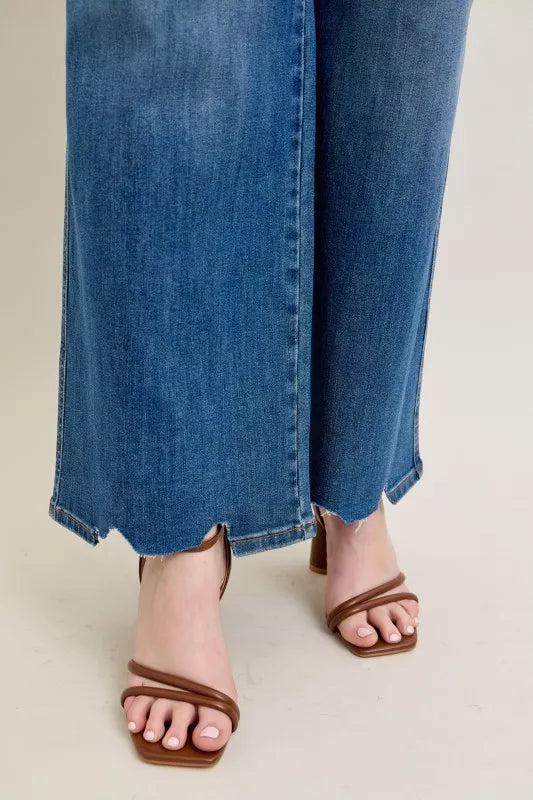 Side view of high-waist wide-leg jeans with chew-destroyed hem edge