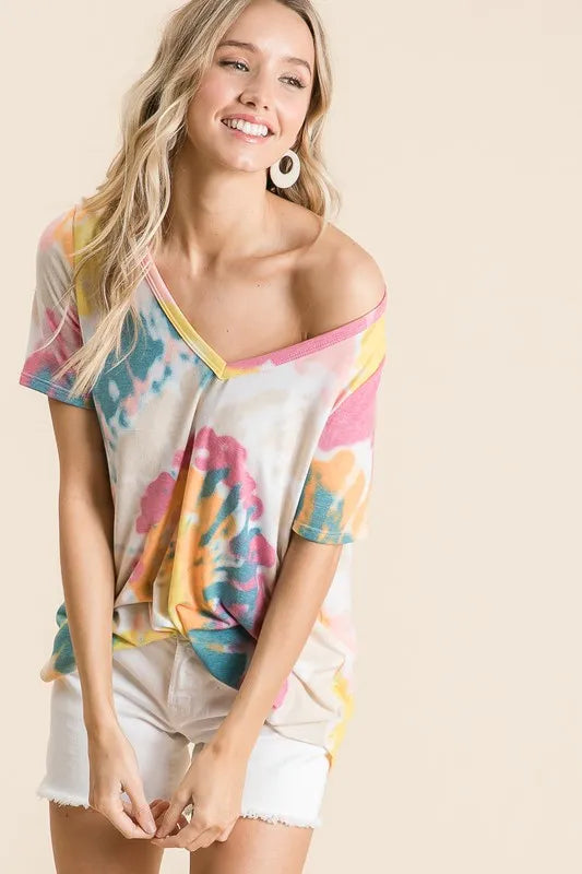V-neck tie-dye top with yellow-orange and pink accents, white base; cuffed short sleeves