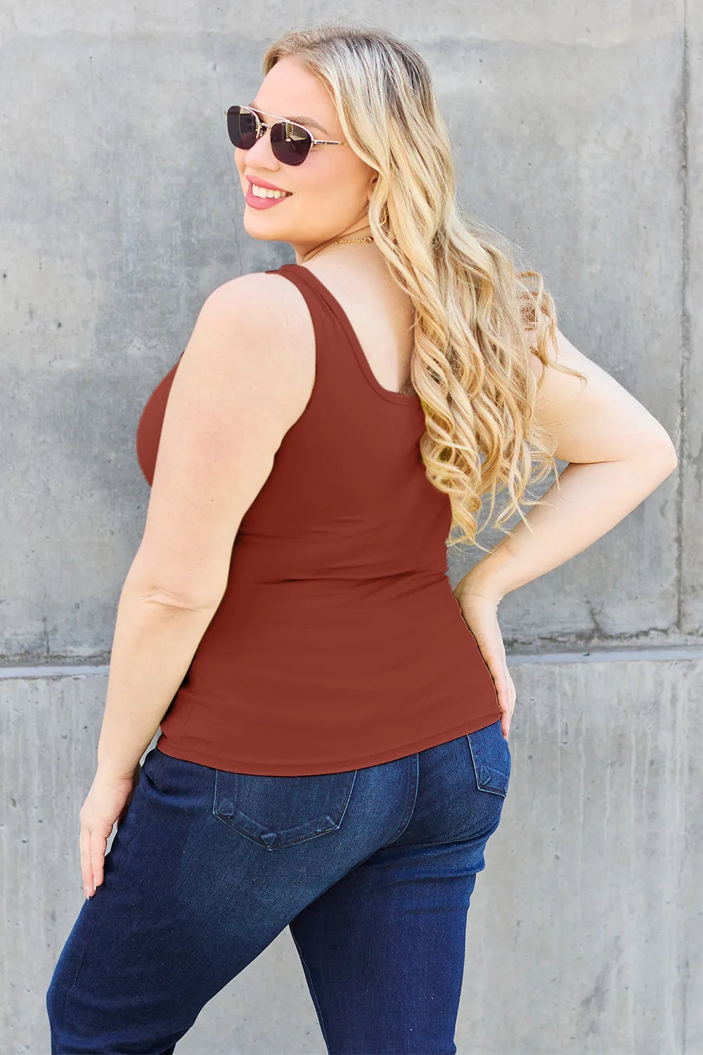 Rust-brown fitted tank top with wide straps and square neckline, side view.