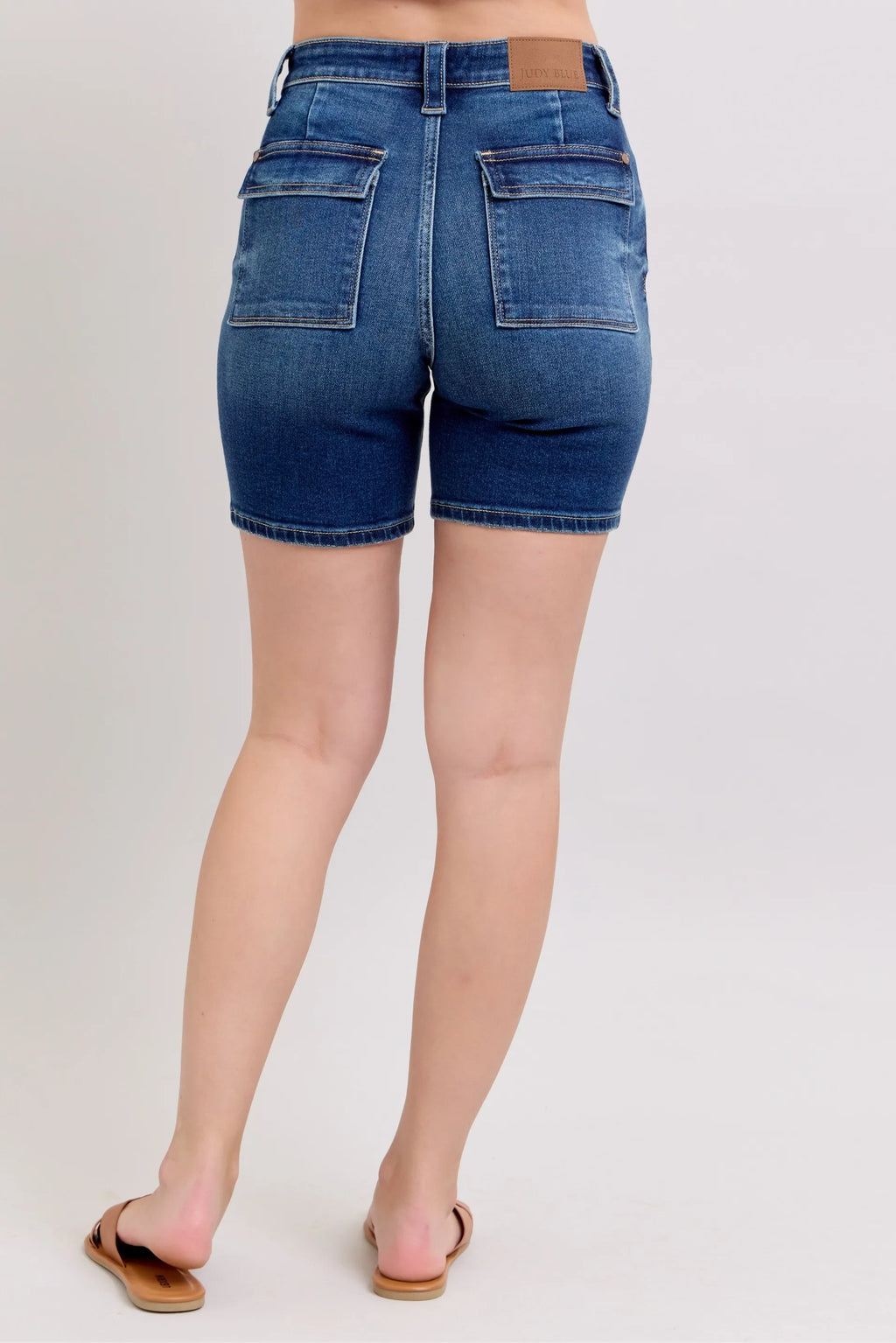 High-waist denim bermuda shorts back view with flap pockets and belt loops