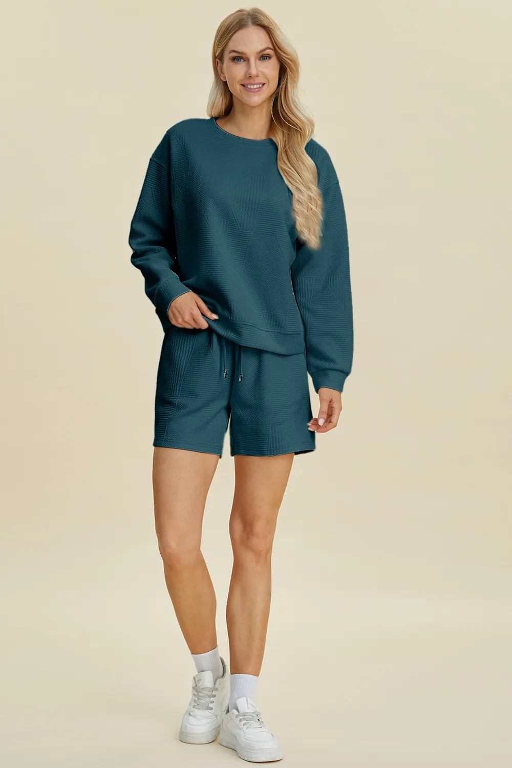 Peacock blue long-sleeve textured top and matching shorts set, full front view.