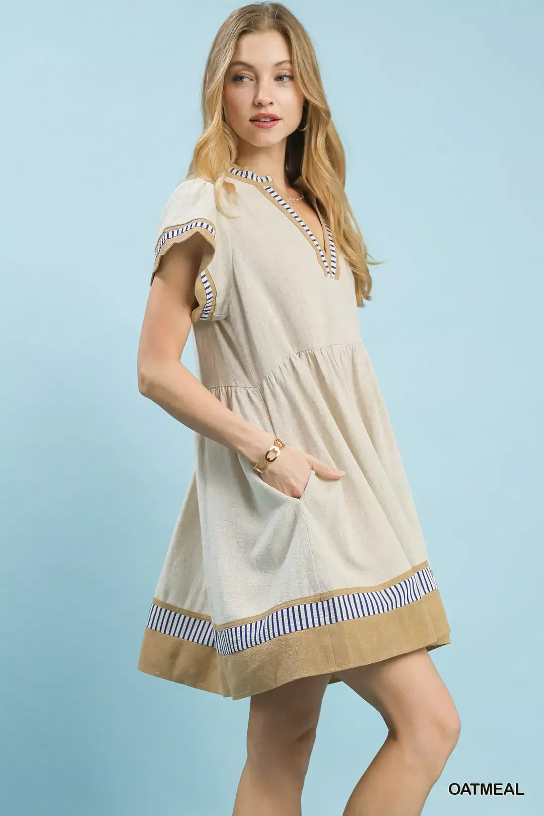 Oatmeal linen dress with flutter sleeves, V-neck, and blue striped hem trim