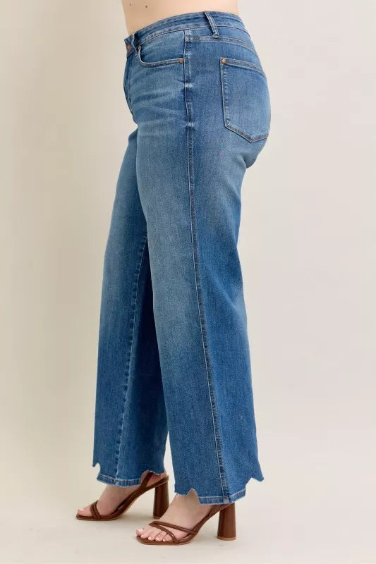 Side/back angle of high-waist wide-leg jeans with destroyed cuff hem