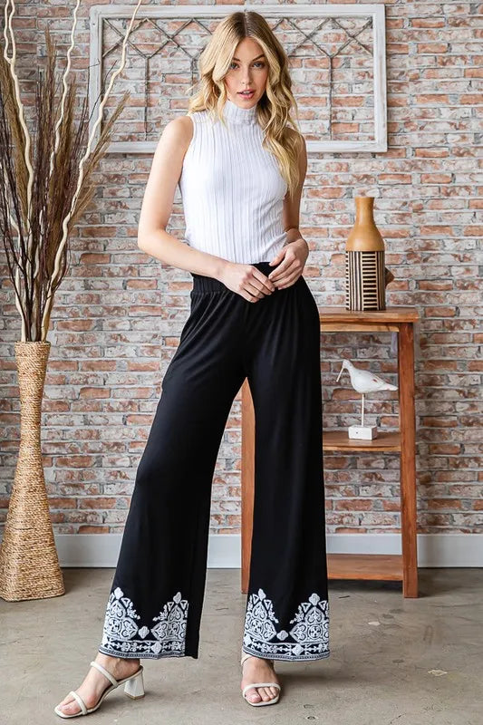 Black pull-on wide-leg pants with patterned damask trim at cuffs