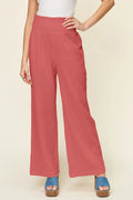 Hot pink wide-leg pants with smocked waist and textured fabric