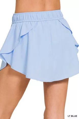 Light blue woven skort with draped side panels and tiered skirt