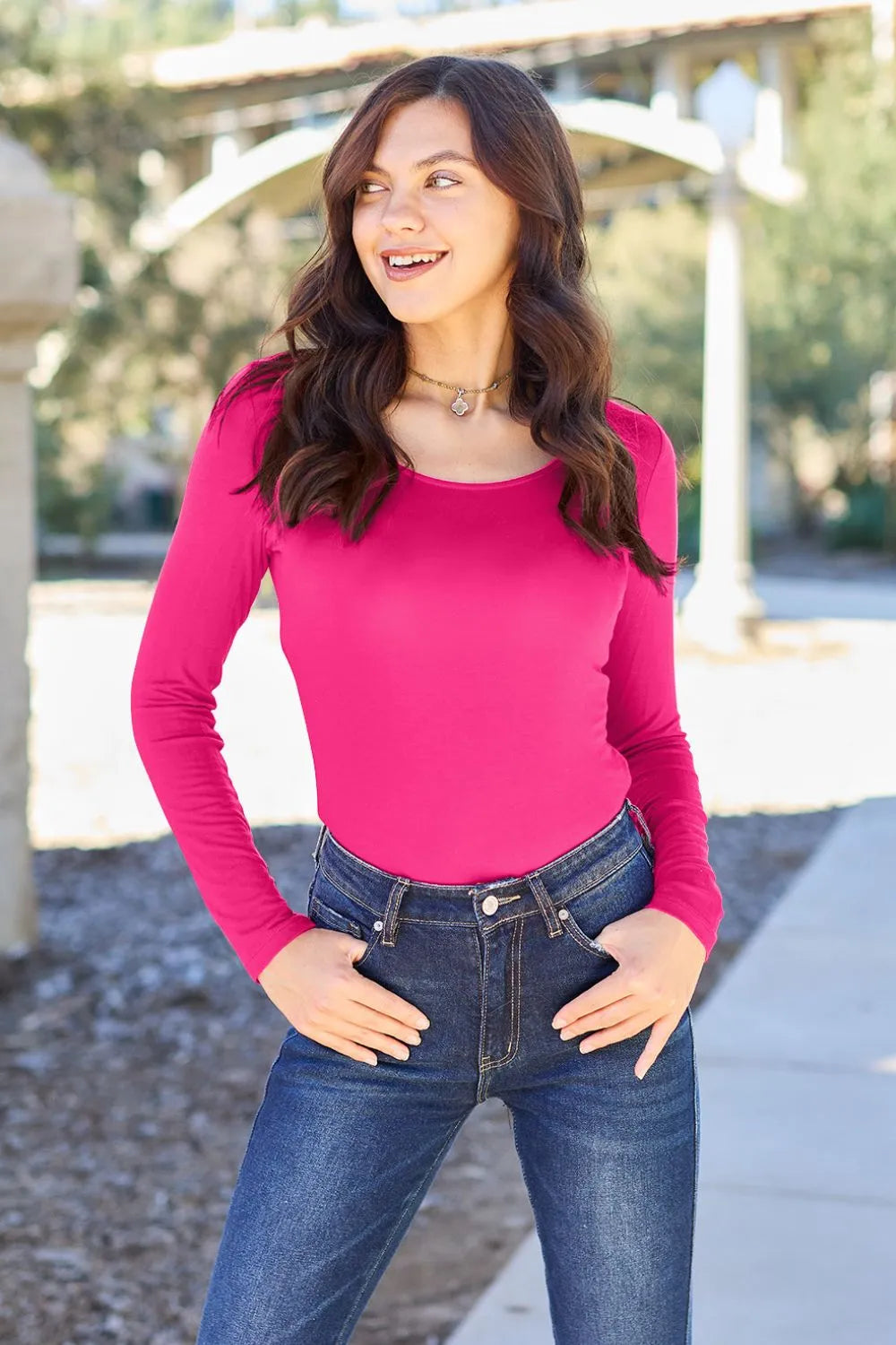 Hot pink long-sleeve round-neck bodysuit, fitted with cheeky bottom