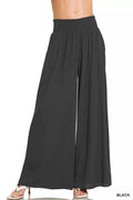 Black smocked-waist wide-leg lounge pants with gathered elastic waistband