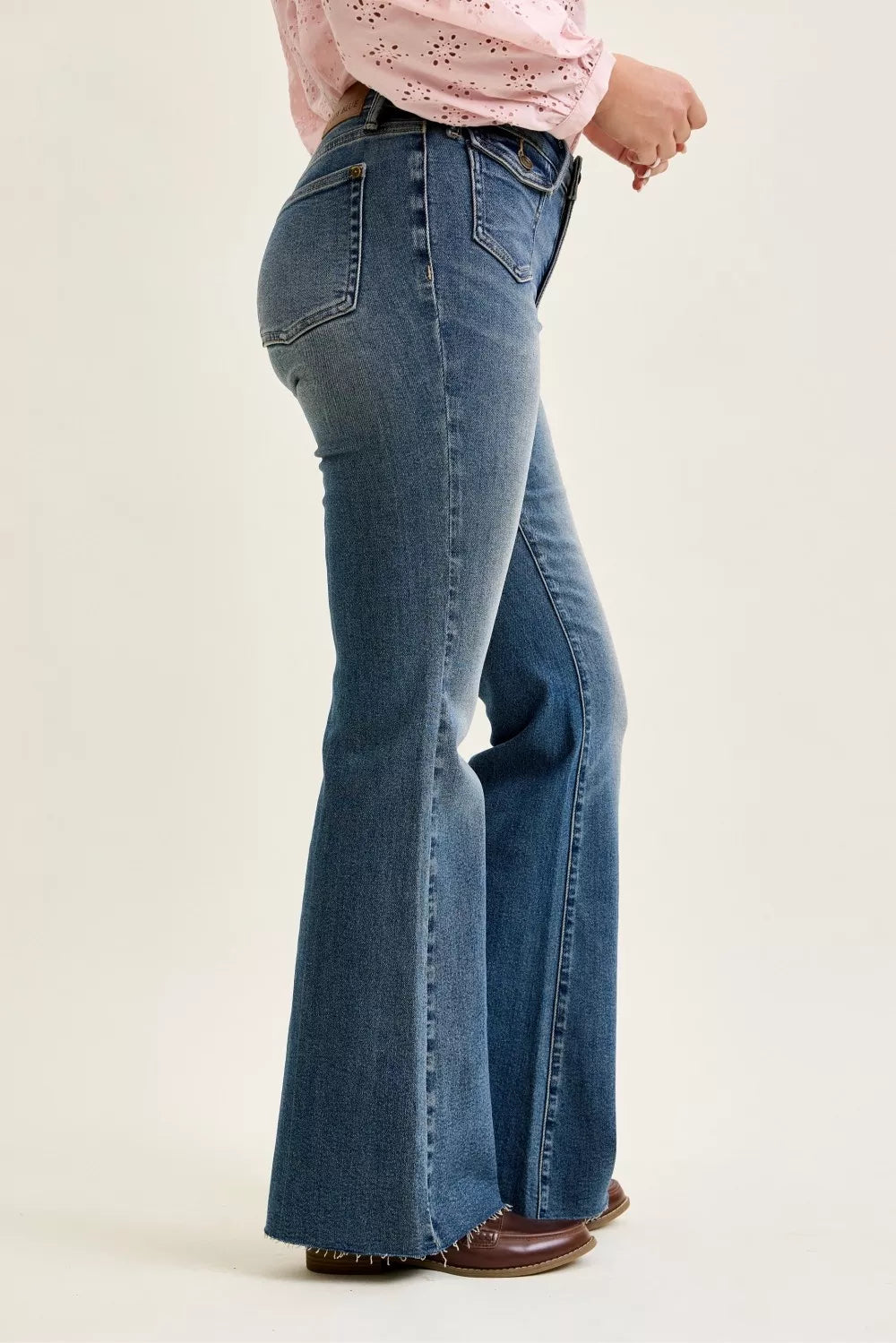 Mid-rise flare jeans with front flap pockets, dark wash denim, side view