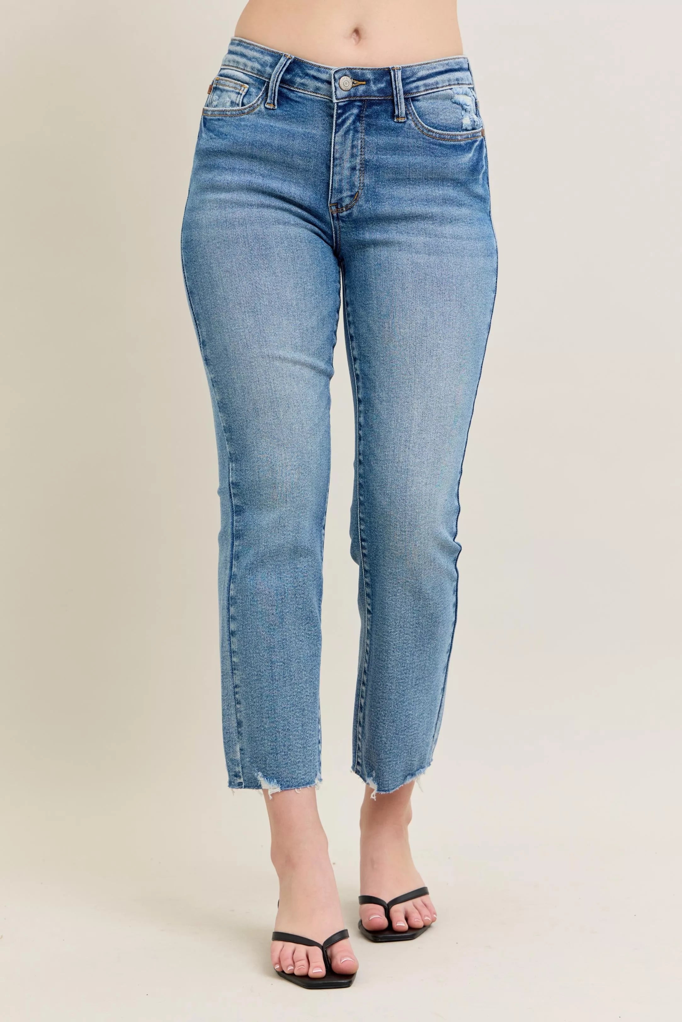 Medium-wash kick flare jeans with ripped frayed hem, front view