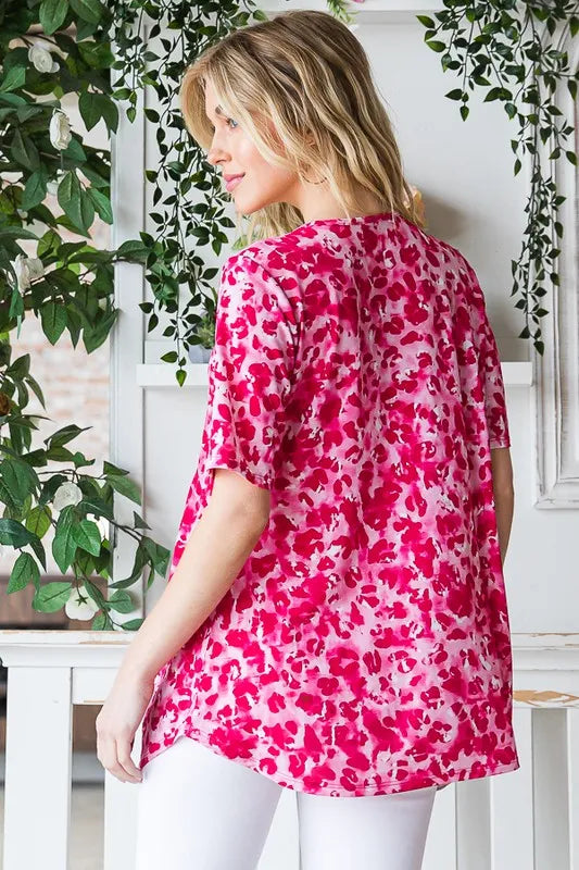 Hot pink animal-print babydoll top with crisscross V-neck, short sleeves