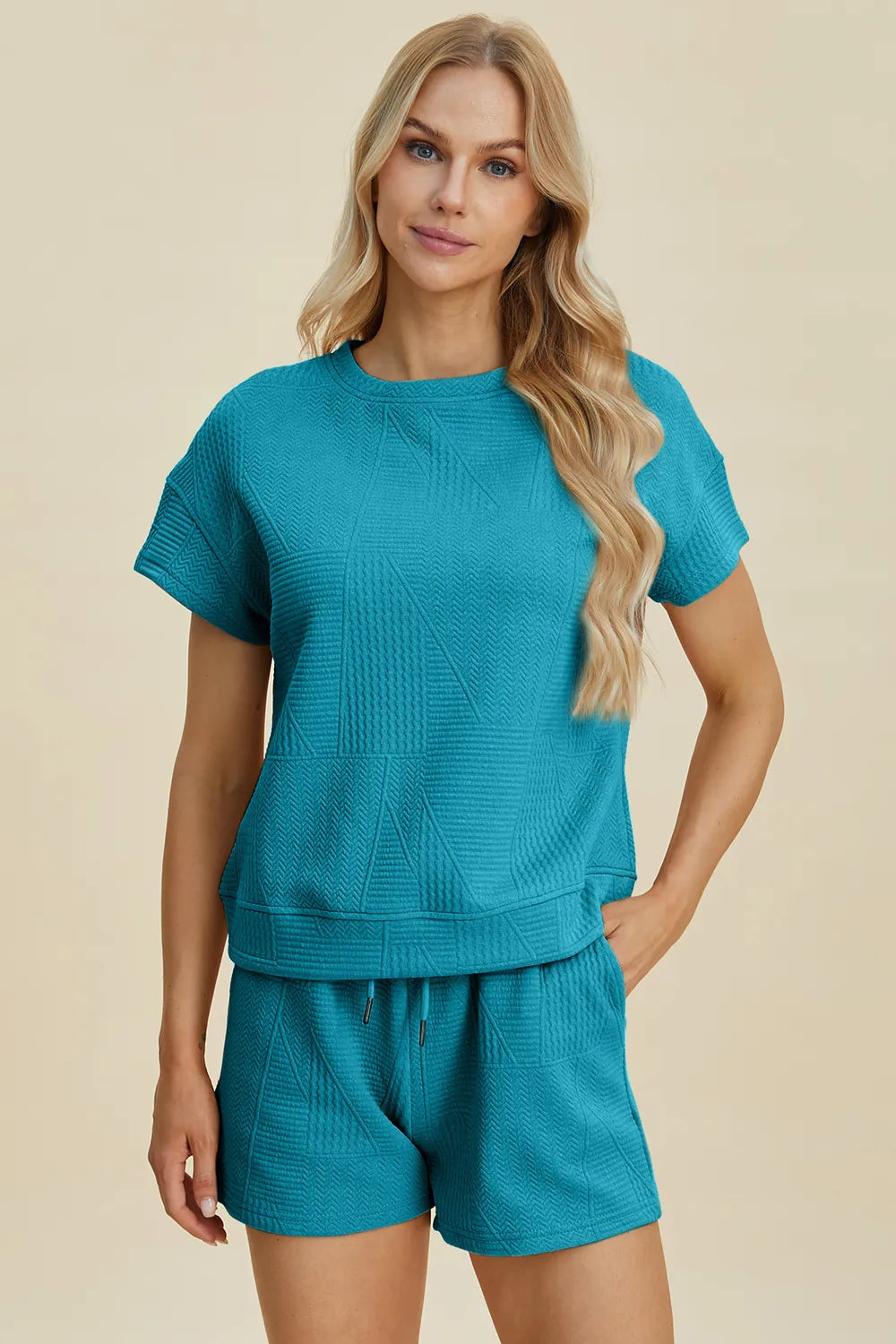 Cerulean short-sleeve textured top with patchwork look; matching drawstring shorts.
