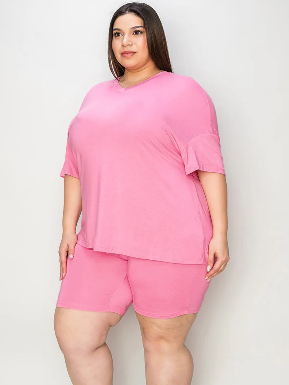 Pink V-neck drop-shoulder T-shirt with matching shorts, angled front view