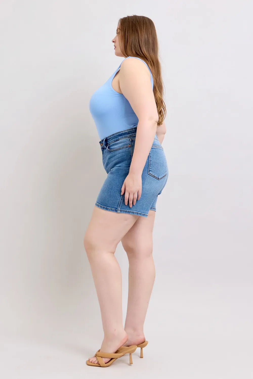 Plus size denim shorts in medium wash with two-button fly and side pockets
