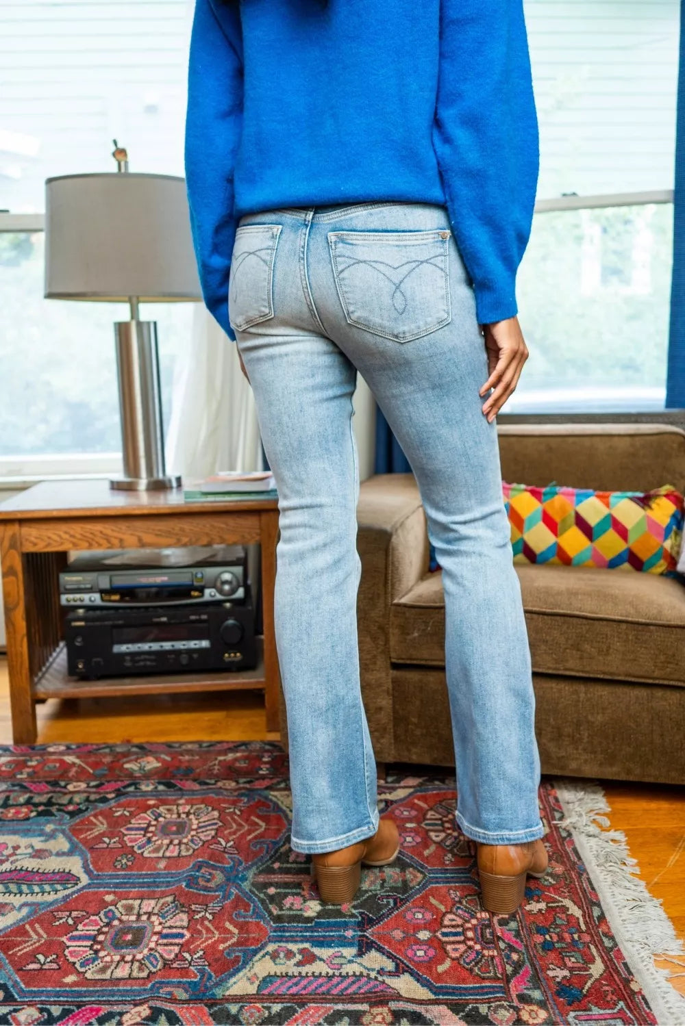 Back view of light wash mid-rise thermal jeans with embroidered pocket detail