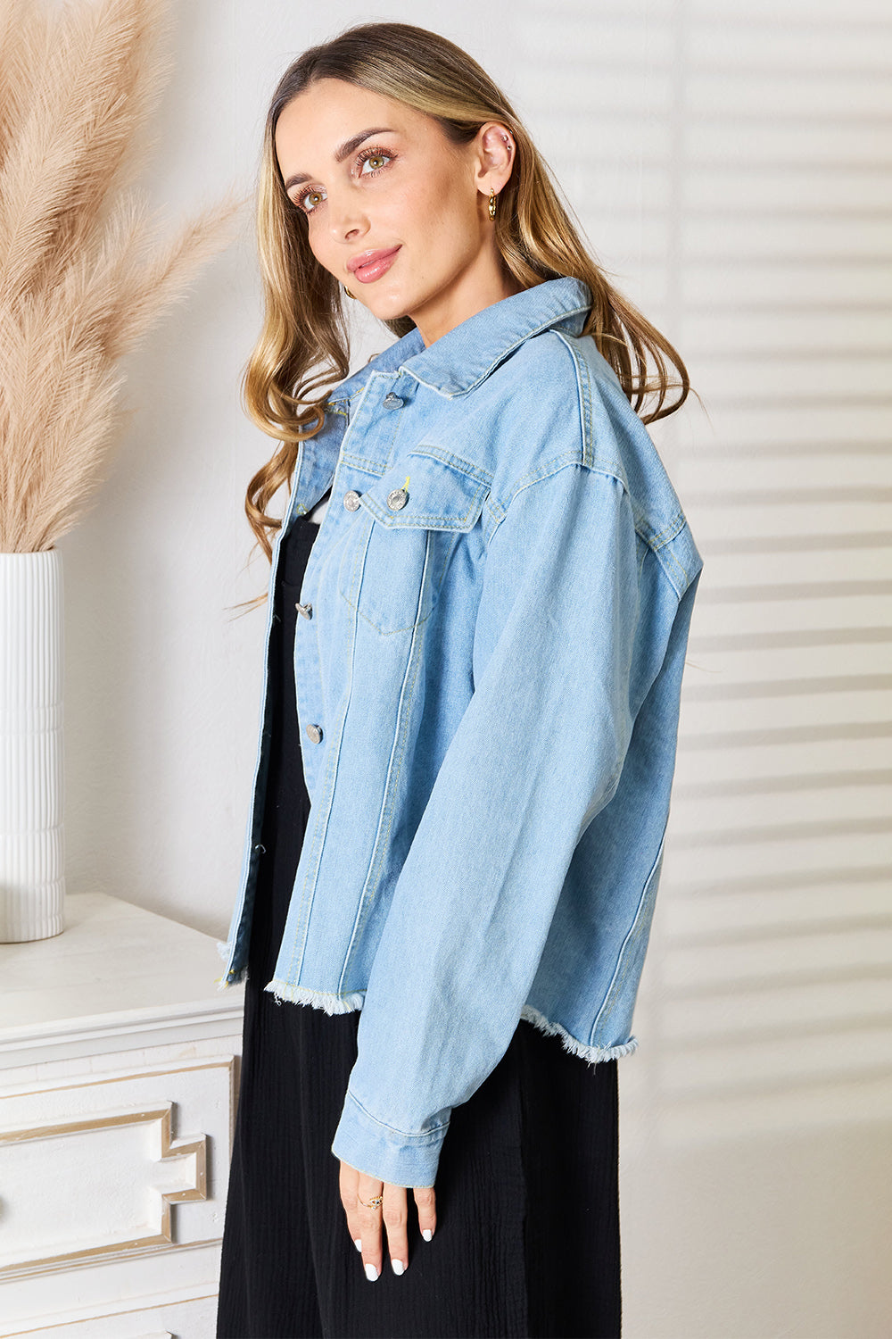Light blue denim jacket, dropped shoulders, raw hem edges, button front, chest flap pockets